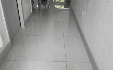 Mirror-polished tile hallway floor maintained through an Ire Cleaning Services recurring cleaning plan