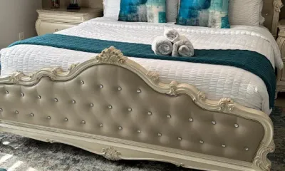 Staged Airbnb bedroom with hotel-style rolled towels after an Ire Cleaning Services turnover clean