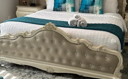 Staged Airbnb bedroom with hotel-style rolled towels after an Ire Cleaning Services turnover clean