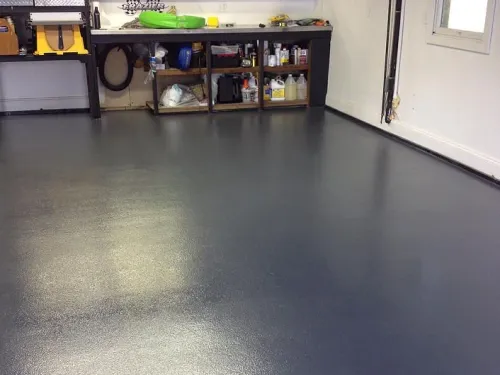 Clean epoxy-coated garage floor with organized workbench